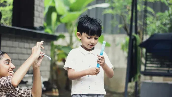 Kid playing with a bubble maker