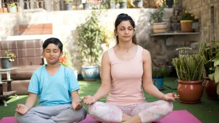 Practical Tips to Reduce Anxiety in Children and Teens - Indian kid and parents doing yoga