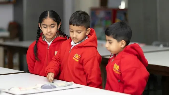 Proven Tips to Boost Memory for Students During Exam Time - Three kids reading from a book