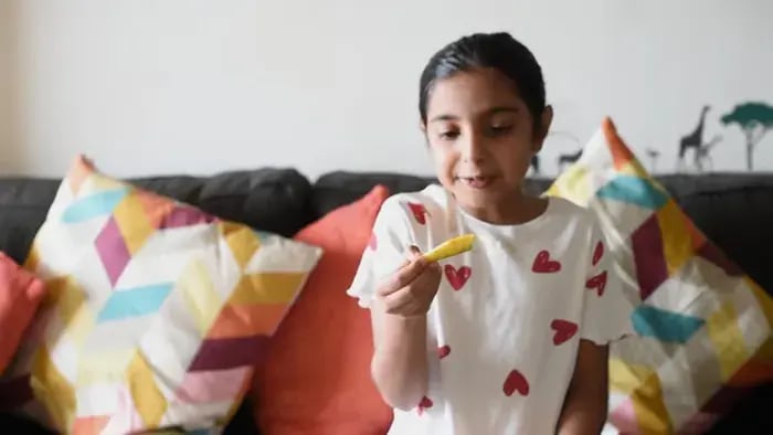 Indian kids eating mangoes