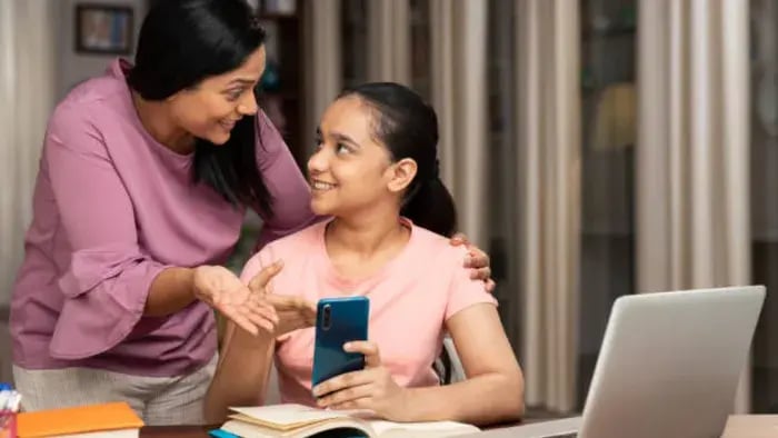 Indian Kid and Parent using Phone