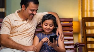 Indian Kid and Parent using Phone