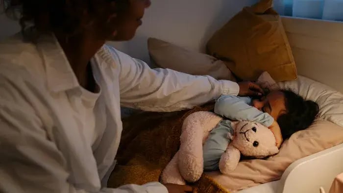 Kid sleeping with a teddy
