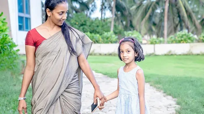 Mother holding daughter's hand