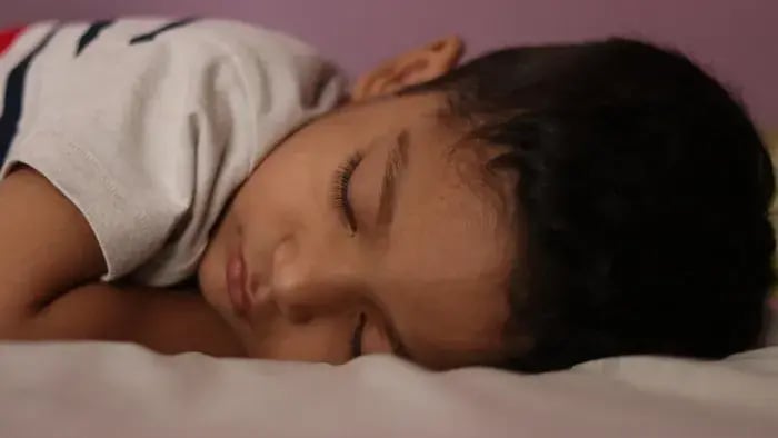 boy sleeping on the bed