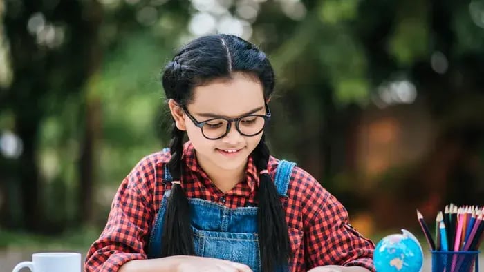 Girl Studying On A Desk