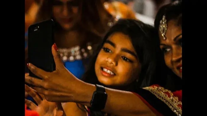 Social Media and Students: Understanding Its Advantages and Disadvantages - Kid using phone to click pictures