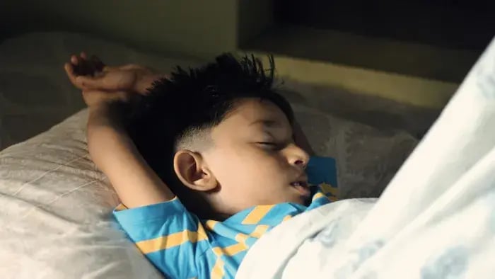 kid sleeping-kid sleeping on a bed