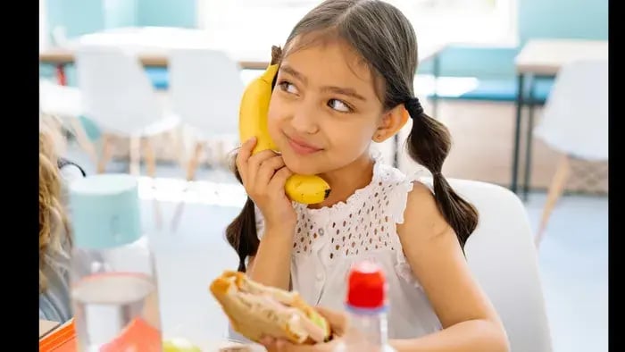 girl with a sandwich and a banana