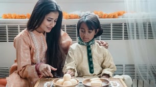 kid sitting with mother on the dining table