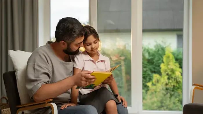 Indian kids with parents reading book