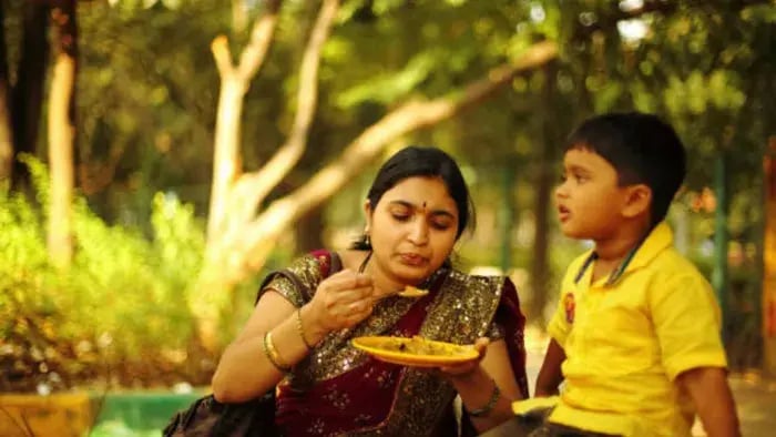 Indian Kid And Parents Eating
