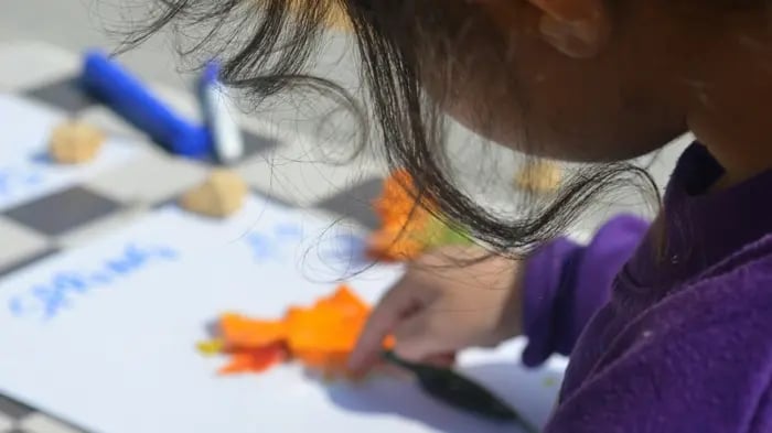 cute Indian child is doing art and craft