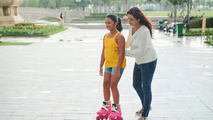 girl skating with her mother
