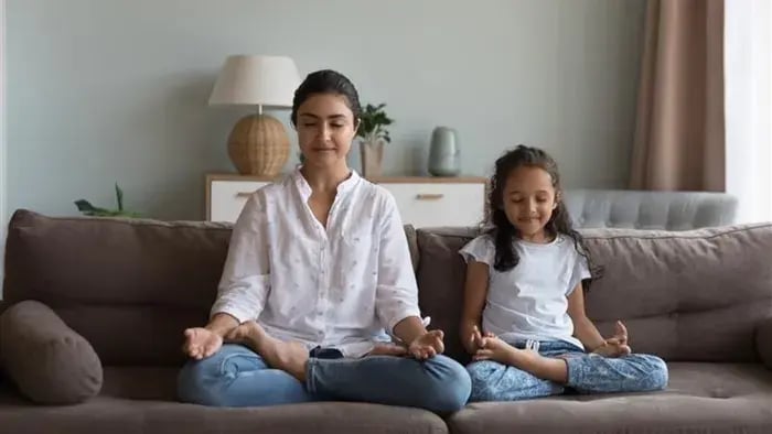 mother doing yoga with kid