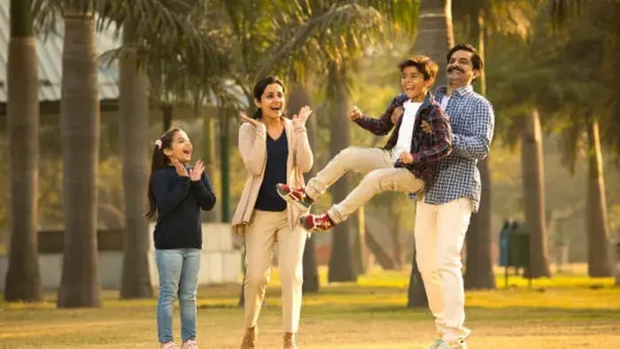 Top 5 Parenting Tips for Raising Resilient and Happy Children - Indian parent playing in park with their kids