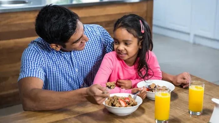 Girl Eating With Father
