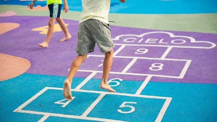 Kid playing hopscotch