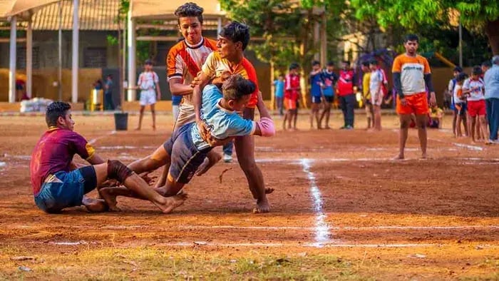 Kids playing kabaddi in a ground