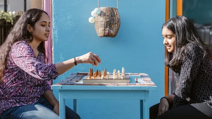 Kid Playing Chess With Mom.