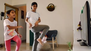 Kid exercising with mother