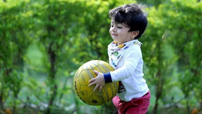 kid playing with a ball