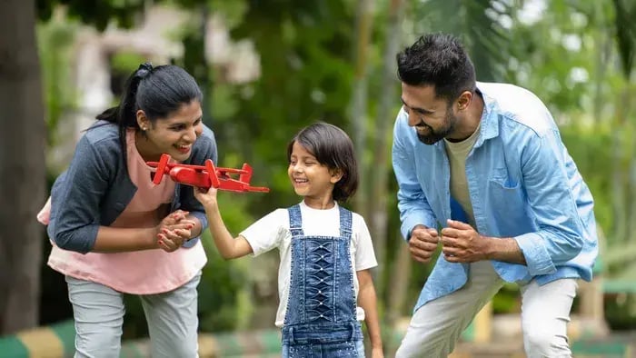 Parents playing with their son
