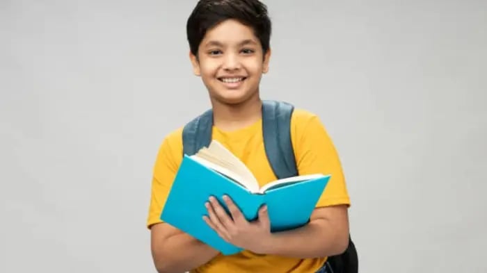 Indian Boy Holding A Hindi Book Of Stories