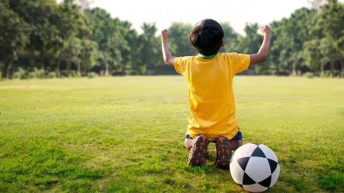 kid playing football