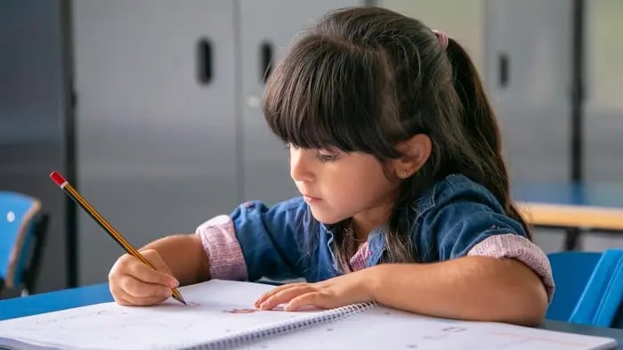 Girl Writing With A Pencil 
