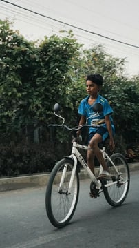 kid cycling in greenery