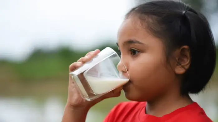 Indian kid drinking hot chocolate