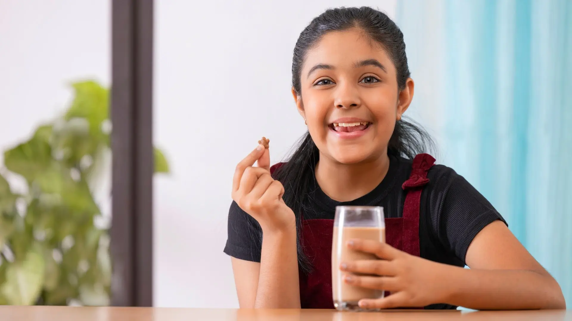 Kid smiling with a glass